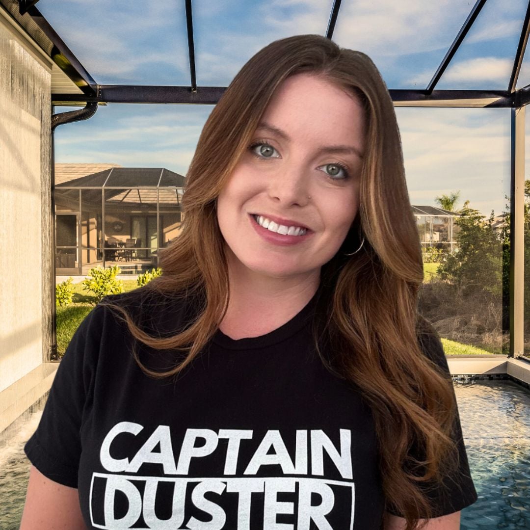 Captain Duster team member finishing up a cleaning job in a modern, sunlit home