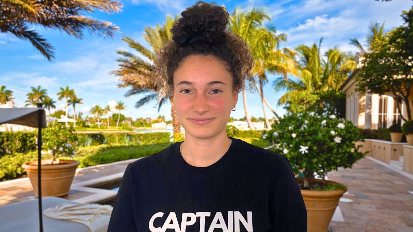 Captain Duster team member smiling in a freshly cleaned back patio with a bright, welcoming atmosphere